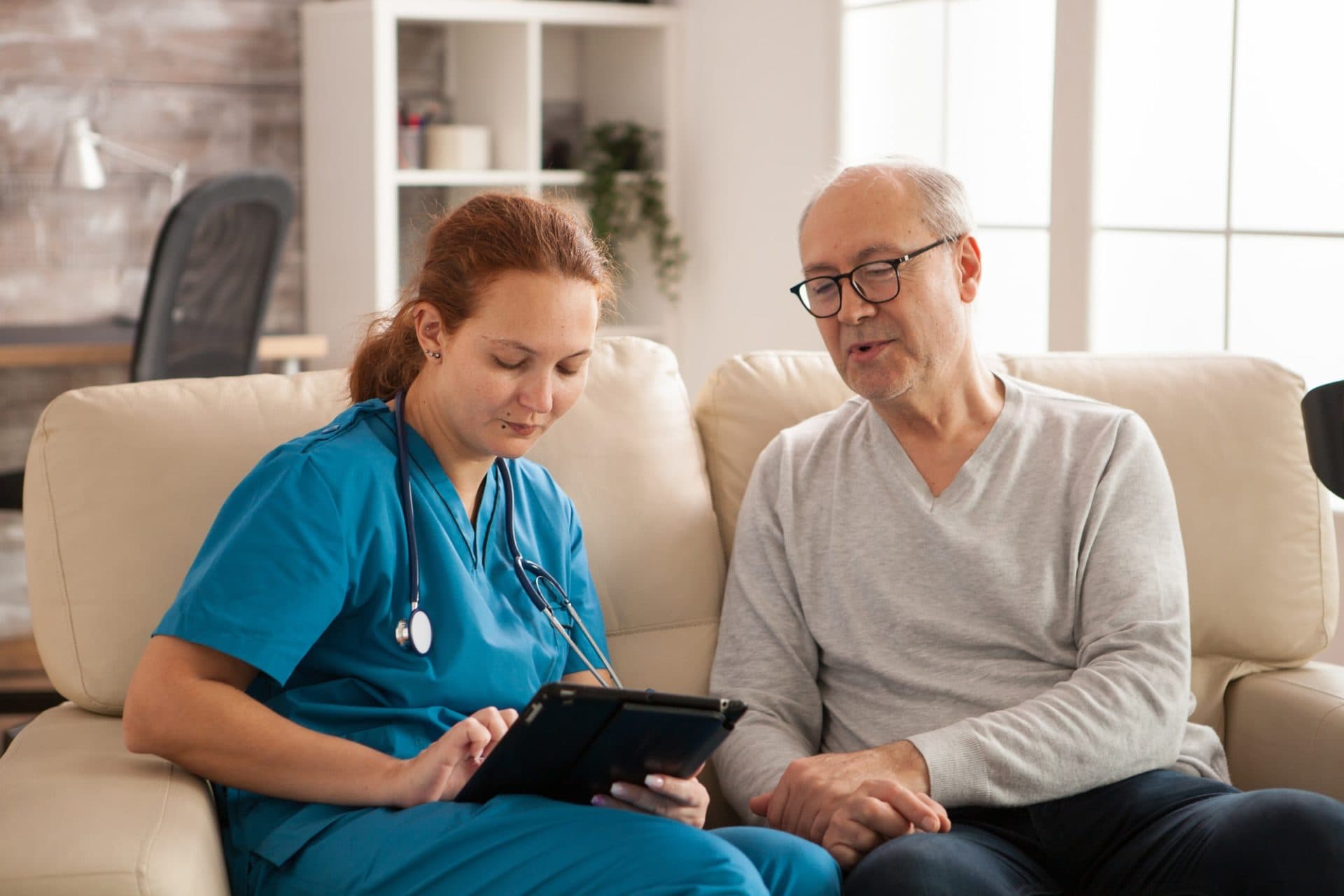 A nurse speaking with an older adult in a home care setting